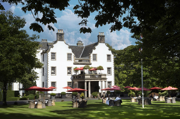 Guests dining alfresco at Prestonfield House, Edinburgh, on a summer's day 