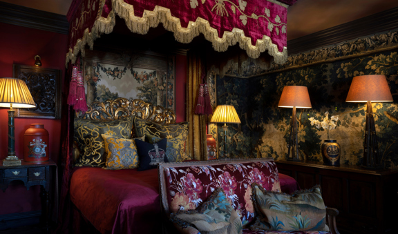 Gothic-style luxury hotel suite with four-poster bed