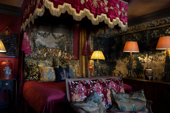 Gothic-style luxury hotel suite with four-poster bed
